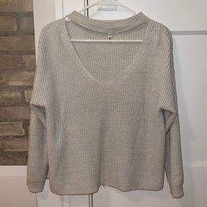 Knit sweater with cutout chest.